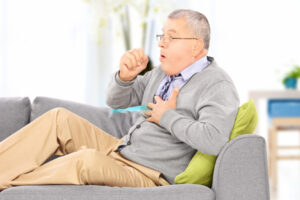 Asthma Man Coughing On The Sofa Shutterstock 163051682